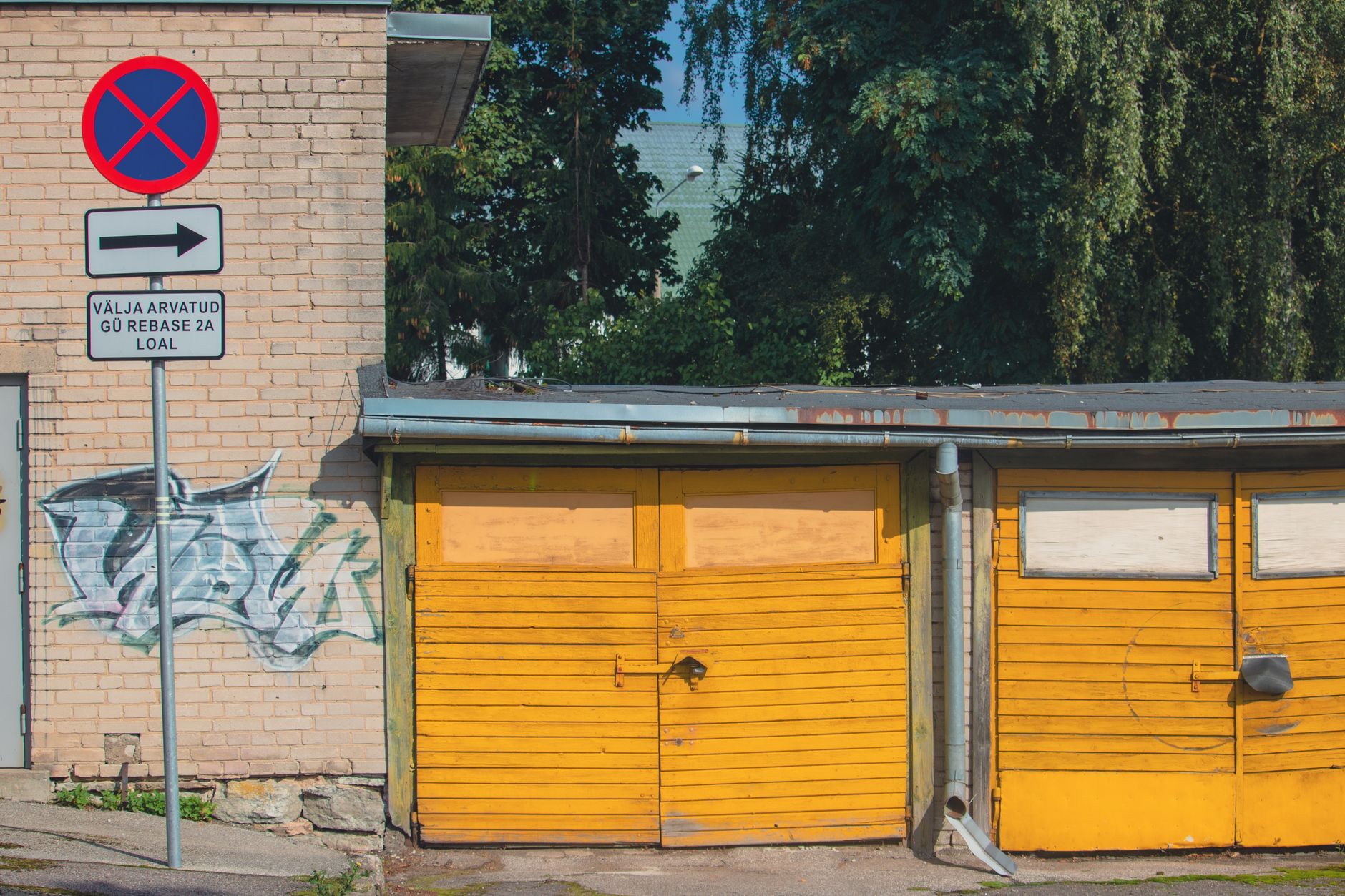 Yellow garage doors on a brick wall