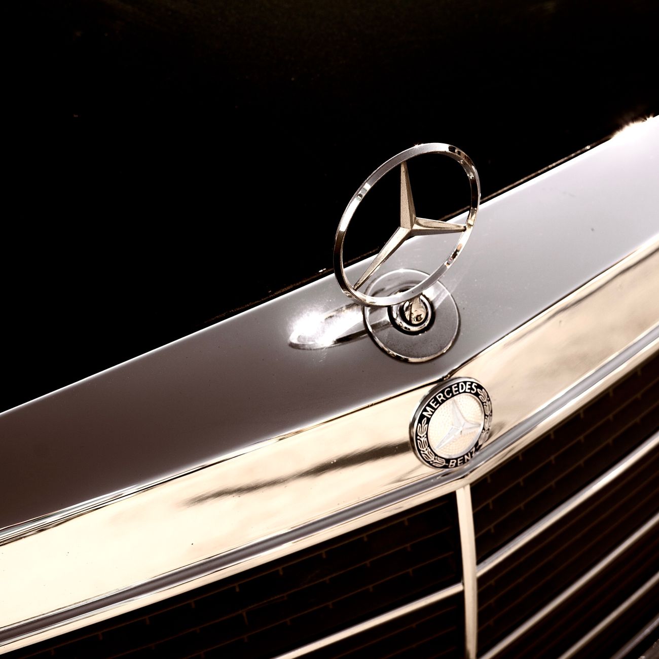 A chrome emblem on a car bonnet, shown close up