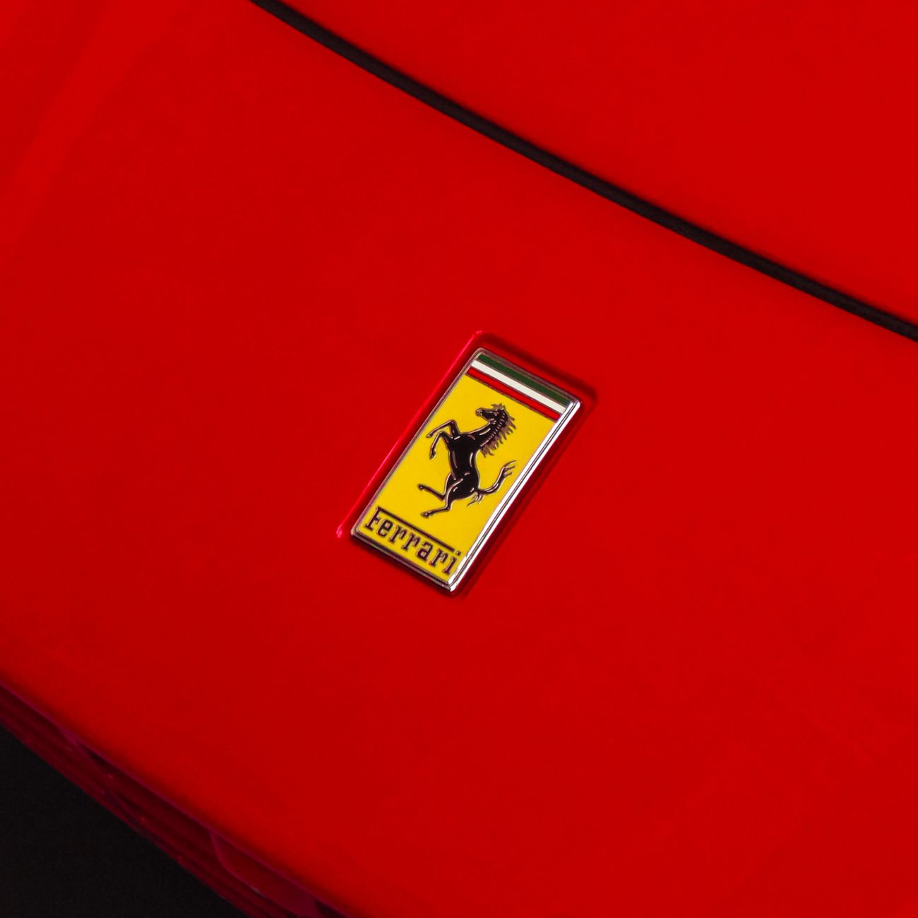 A red sports car bonnet with its emblem