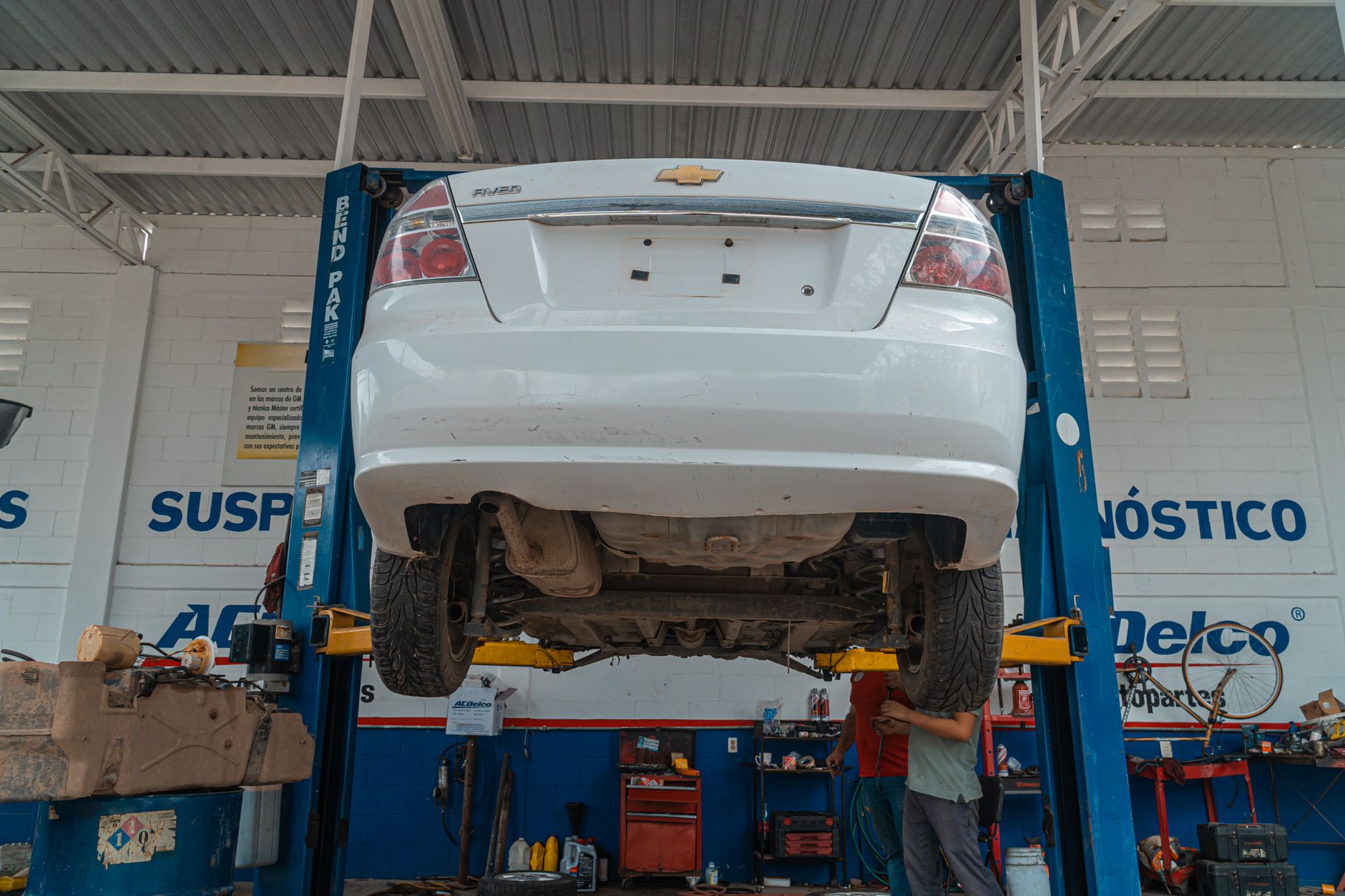 A car raised on a lift for suspension inspection