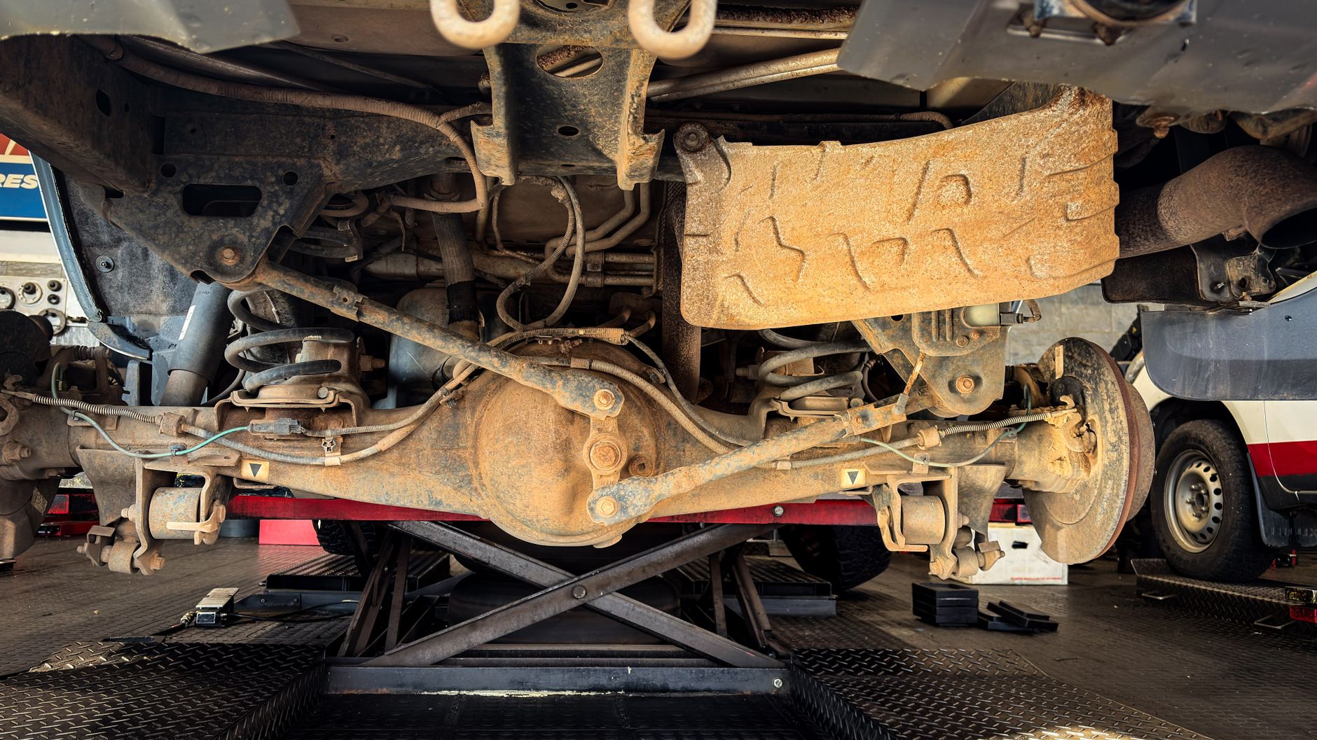 Photo of a a car suspension under repair in a garage