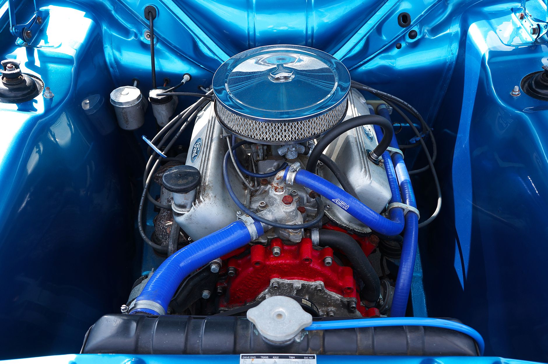 A classic car engine with chrome parts, clean and detailed