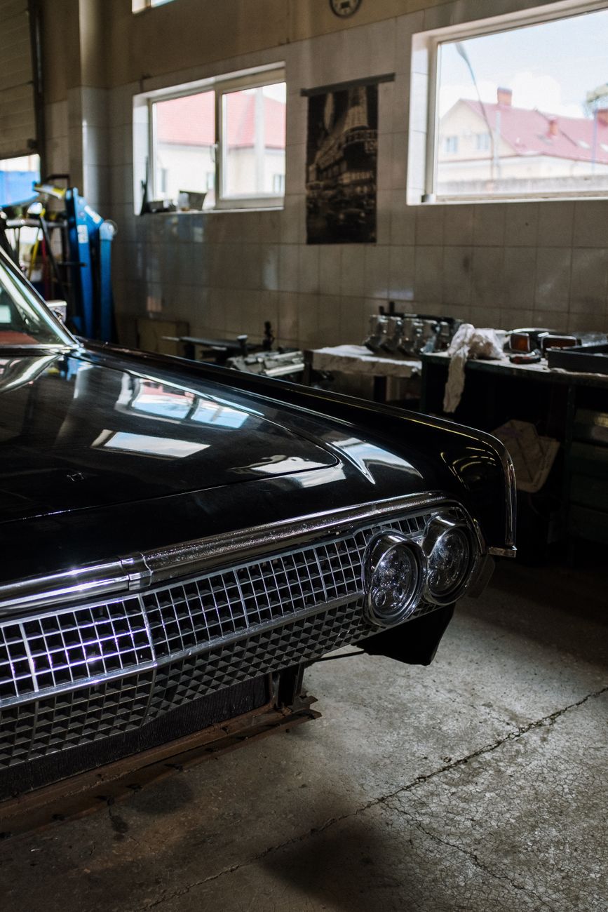 A classic car in the garage with its vintage details visible