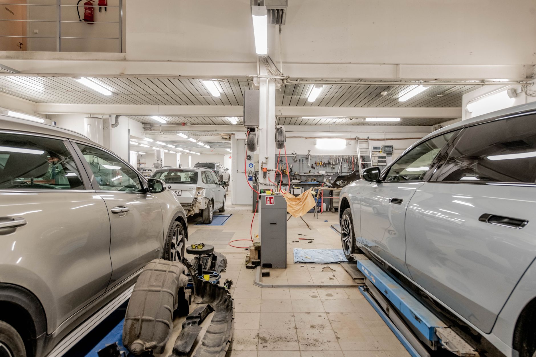 A service bay with cars undergoing maintenance