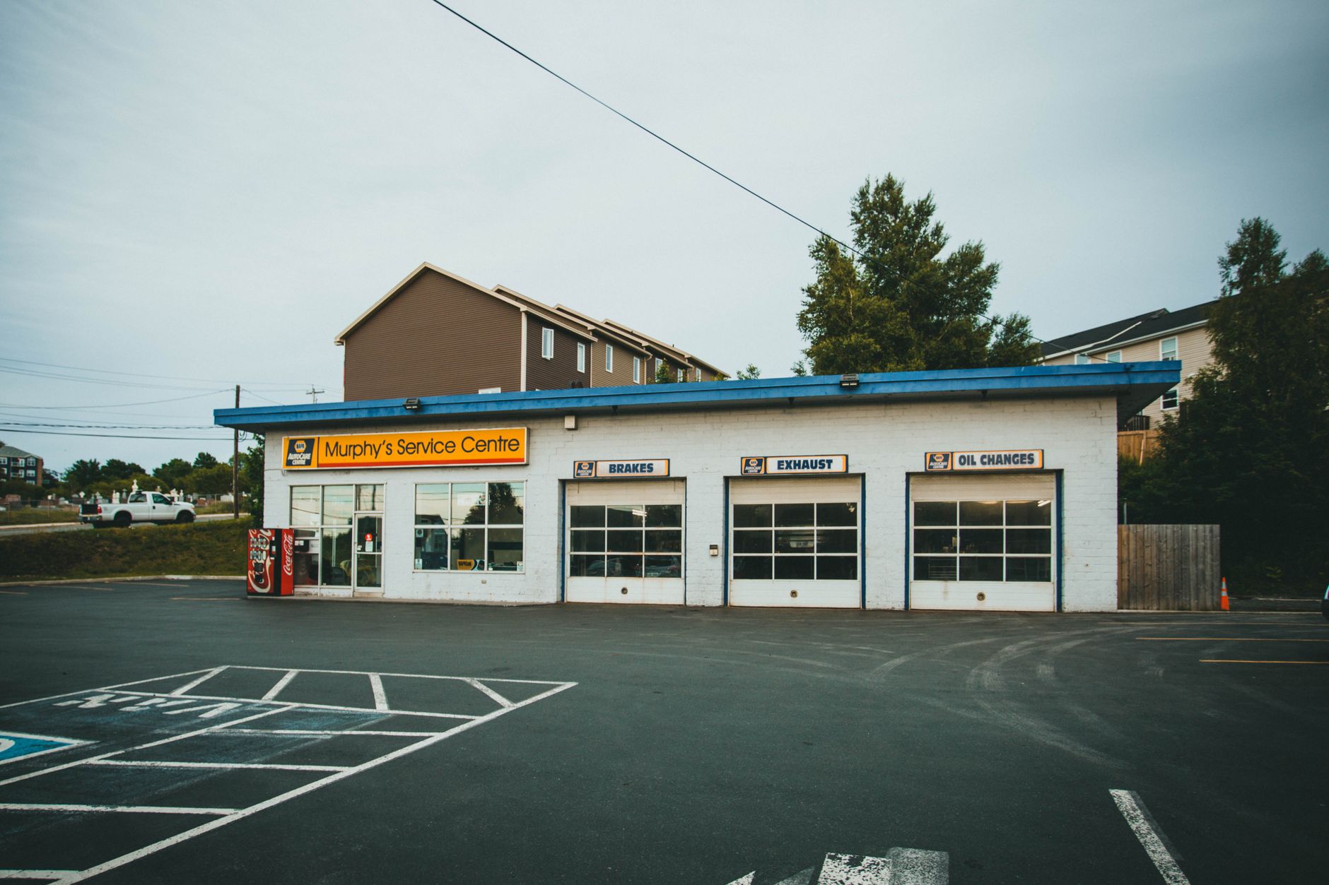 The exterior of a service centre with a workshop and parking area