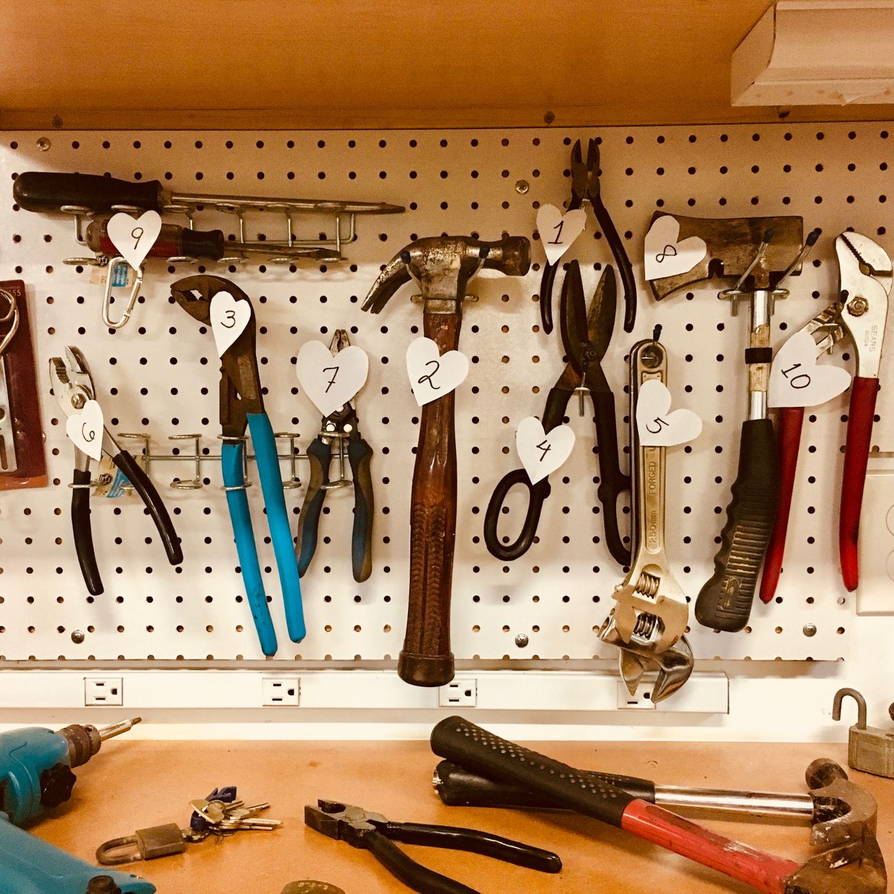 Tools arranged on a pegboard in a well-lit workshop