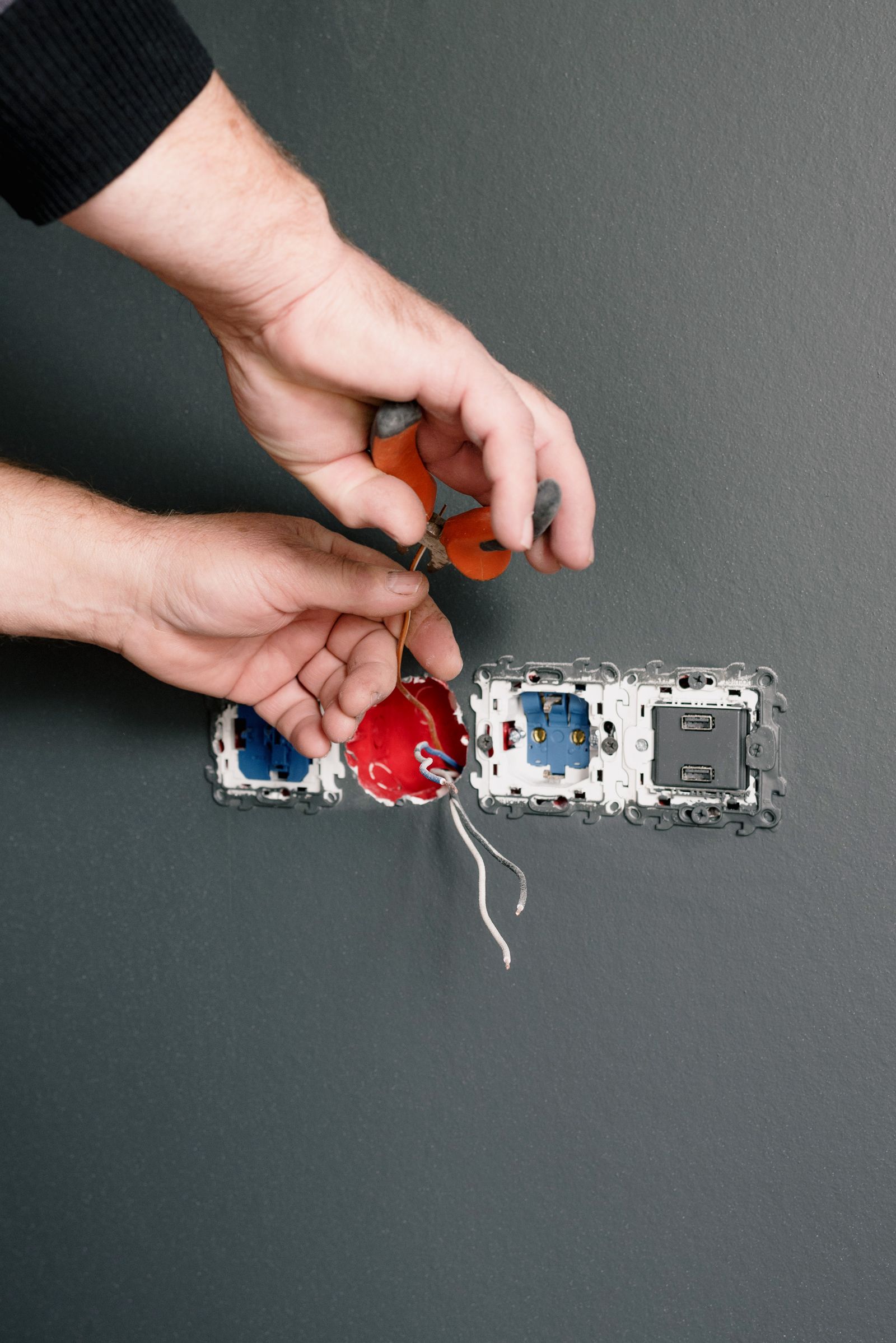 Electrician repairing electrical sockets and wiring
