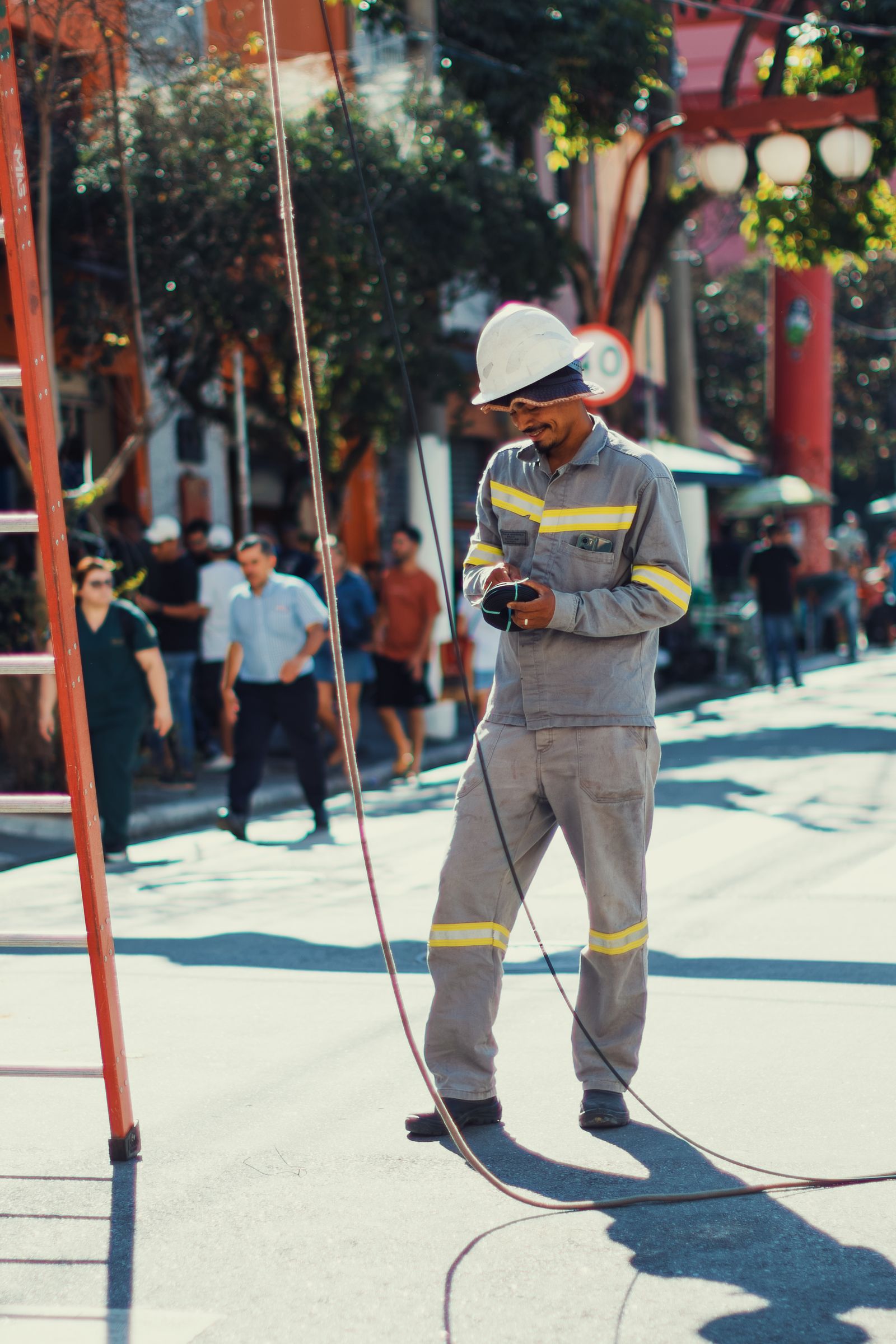 Utility electrician working outdoors with cables